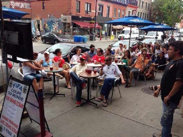Portugal supporters taking in the sunshine and the World Cup match against Germany at Café Saint Laurent Frappé in Montreal on June 16, 2014.