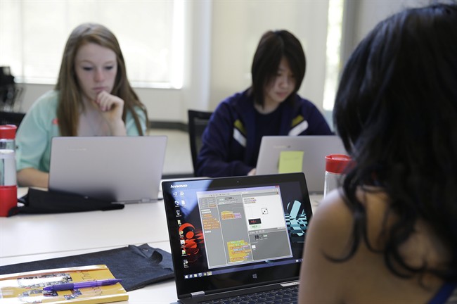 A group of high school girls work at completing an exercise during a Girls Who Code class at Adobe Systems in San Jose, Calif.