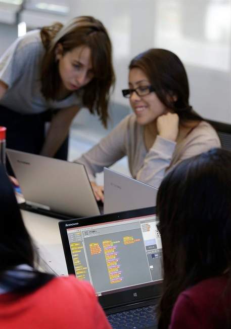 File photo of an educational assistant helping a student. 