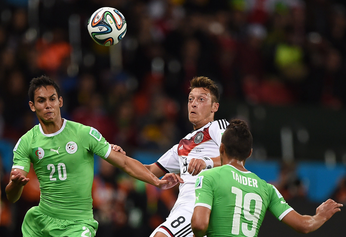Algeria's defender Aissa Mandi, Germany's midfielder Mesut Ozil and Algeria's midfielder Saphir Taider vie for the ball during a Round of 16 football match between Germany and Algeria at Beira-Rio Stadium in Porto Alegre during the 2014 FIFA World Cup on June 30, 2014. AFP PHOTO / KIRILL KUDRYAVTSEV (Photo credit should read KIRILL KUDRYAVTSEV/AFP/Getty Images)