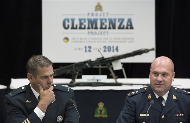 Mario Desmarais, left, with the Montreal Police Department and Michel Arcand with the RCMP speak to reporters during a news conference at RCMP headquarters in Montreal, Thursday, June 12, 2014.