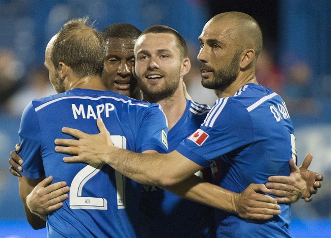 Montreal Impact's Jack McInerney, second right, celebrates with teammates, from left, Justin Mapp, Patrice Bernier and Marco Di Vaio after scoring against the Houston Dynamo.