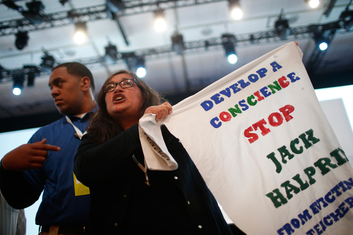 A demonstrator waves a sign in protest of Google during the Google I/O Developers Conference at Moscone Center on June 25.