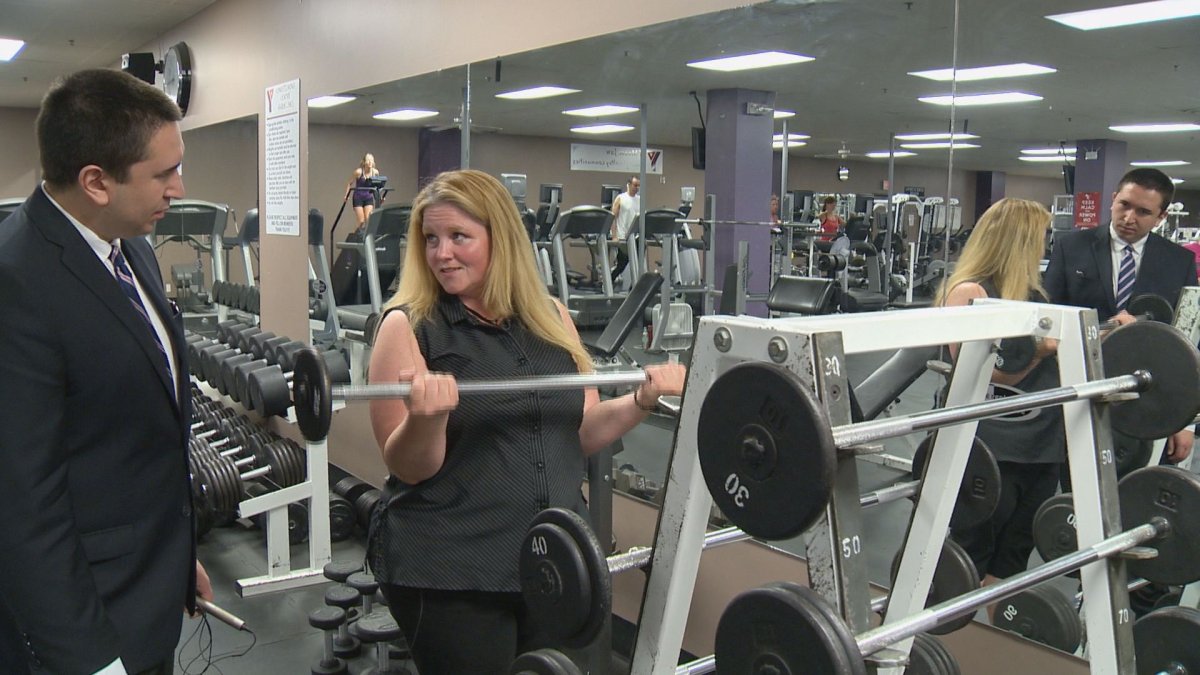 Lisa Abbasi shows off how much weight she can bench press on Monday at Moose Jaw's YMCA Athabasca now that she has graduated from the program.