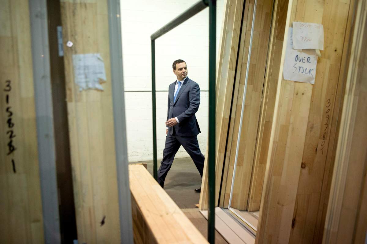 Ontario PC Leader Tim Hudak leaves a campaign rally at a windows manufacturer in Mississauga, Ont. on Wednesday June 11, 2014, as he continues his election campaign. 