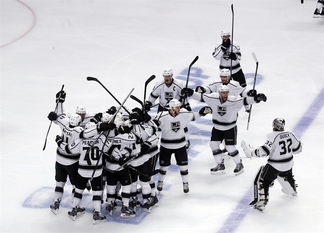 Los Angeles Kings celebrate after defeating Chicago Blackhawks 5-4 in the overtime period in Game 7 of the Western Conference finals in the NHL hockey Stanley Cup playoffs Sunday, June 1, 2014, in Chicago.