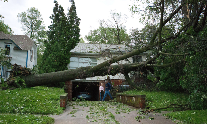 Dick and Laurel Rapp survey the damage to their home on Park Street in Oakland, Iowa on Tuesday, June 3, 2014. 