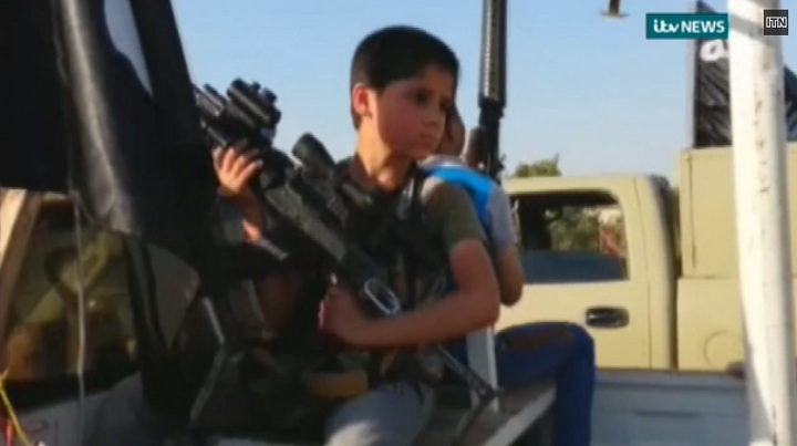 A new video shows children holding guns in an ISIS convoy in Mosul, Iraq