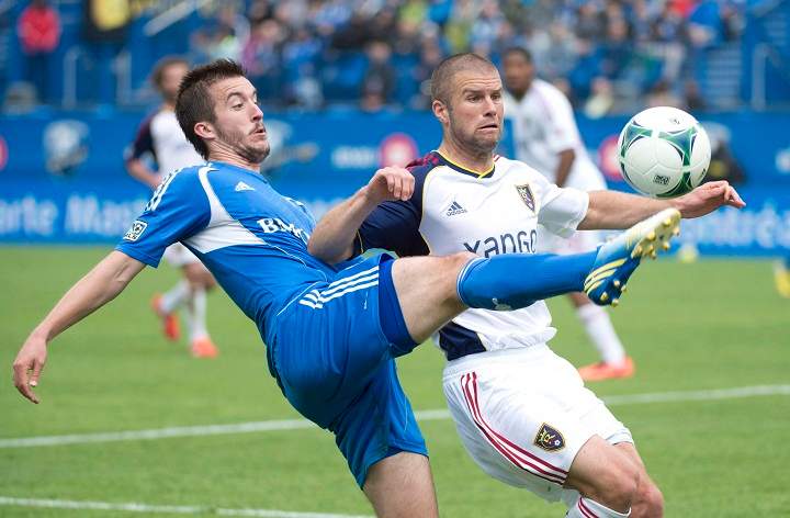 Montreal Impact's Jeb Brovsky, left, tackles Real Salt Lake's Chris Wingert during first half MLS soccer action in Montreal, Saturday, May 11, 2013.