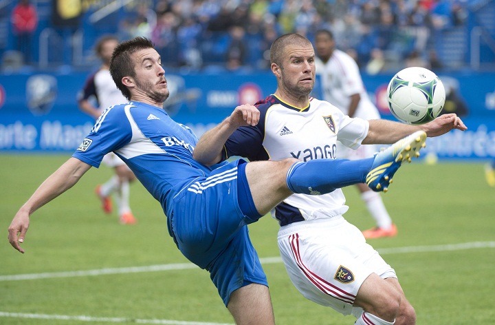 Montreal Impact's Jeb Brovsky, left, tackles Real Salt Lake's Chris Wingert during first half MLS soccer action in Montreal, Saturday, May 11, 2013.