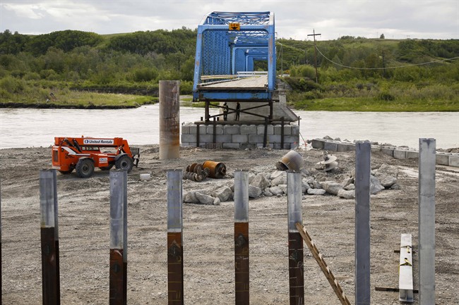 Reconstruction continues on a bridge over the Bow River that was destroyed by flooding one year after a devastating flood in Siksika, Alta., Thursday, June 5, 2014.