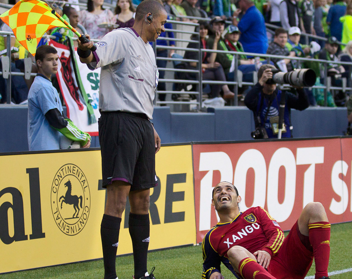 In this FILE photo, Real Salt Lake's Fabian Espíndola, right, jokes with Canadian referee's assitant Joe Fletcher during the second half of play in a MLS soccer match, Saturday, May 12, 2012, in Seattle.
