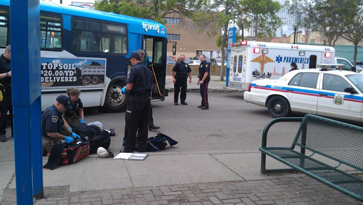 A pedestrian is treated at the bus mall in Saskatoon after he was hit by a transit bus on June 17, 2014.