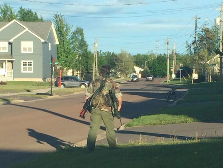 Two guns are seen on the back of an armed man, believed to be Justin Bourque, in Moncton, N.B., on June 4.