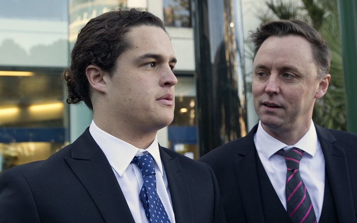 In this Monday, June 23, 2014 photo, sixteen-year-old Lucan Battison, left, with his lawyer, Jol Bates, arrives at the High Court in Wellington, New Zealand, where Battison is fighting his suspension from his Catholic high school because of his long hair. 