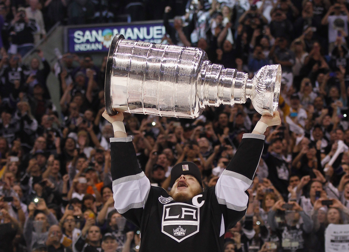 LOS ANGELES, CA - JUNE 11: Dustin Brown #23 of the Los Angeles Kings holds up the Stanley Cup after the Kings defeated the New Jersey Devils 6-1 to win the Stanley Cup series 4-2 in Game Six of the 2012 Stanley Cup Final at Staples Center on June 11, 2012 in Los Angeles, California. (Photo by Bruce Bennett/Getty Images)