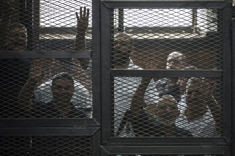 Egyptian Muslim Brotherhood leader Mohamed Badie (2nd R) and other defendants gesture during their trial in the capital Cairo on June 7, 2014. AFP PHOTO /KHALED DESOUKI .