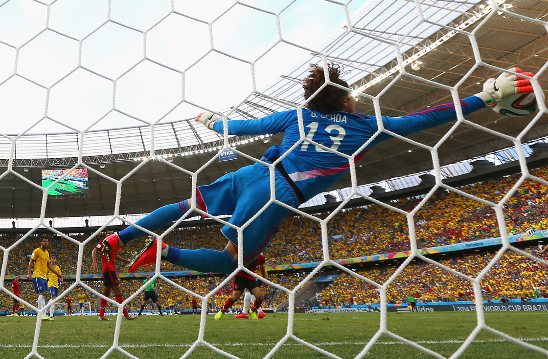 FORTALEZA, BRAZIL - JUNE 17: Guillermo Ochoa of Mexico dives to make a save during the 2014 FIFA World Cup Brazil Group A match between Brazil and Mexico at Castelao on June 17, 2014 in Fortaleza, Brazil. (Photo by Robert Cianflone/Getty Images)