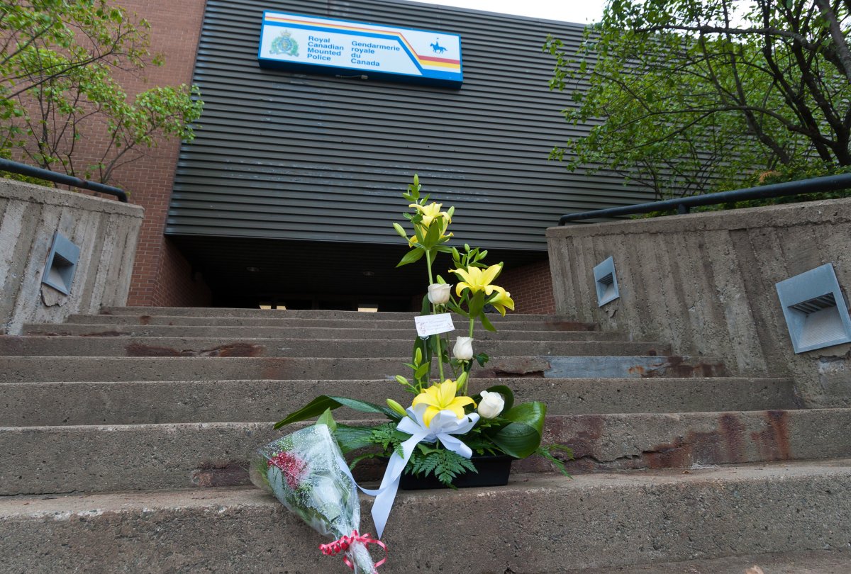 A makeshift memorial takes form on the steps of Codiac RCMP headquarters in downtown Moncton, N.B. on Thursday June 5, 2014. THE CANADIAN PRESS/Marc Grandmaison.
