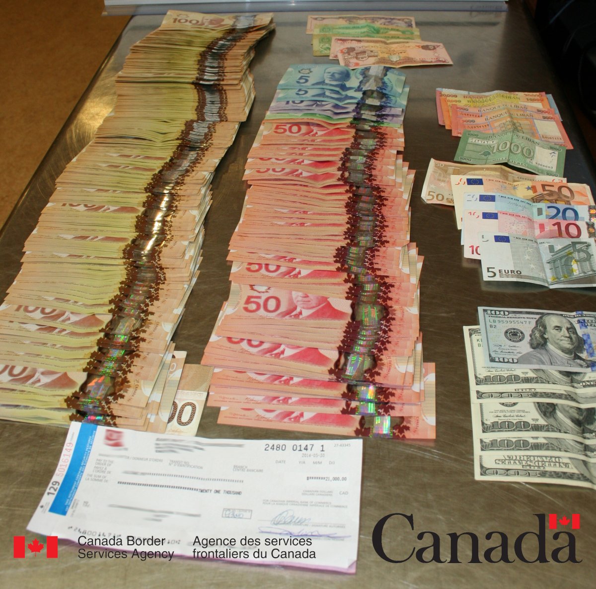 Nearly $68,000 in currency seized by CBSA officers at the Edmonton International Airport. June 5, 2014. 