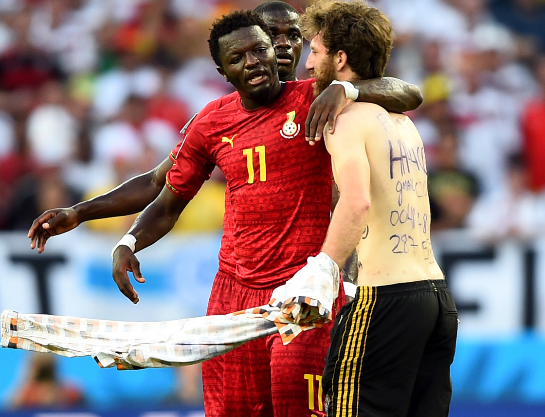 A pitch invader hugs Sulley Muntari of Ghana during the 2014 FIFA World Cup Brazil Group G match between Germany and Ghana at Castelao on June 21, 2014 in Fortaleza, Brazil. (Photo by Laurence Griffiths/Getty Images)
