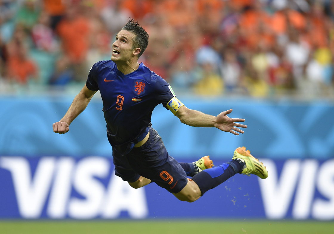 Netherlands' forward Robin van Persie scores during a Group B football match between Spain and the Netherlands at the Fonte Nova Arena in Salvador during the 2014 FIFA World Cup on June 13, 2014. AFP PHOTO / LLUIS GENE (Photo credit should read LLUIS GENE/AFP/Getty Images)