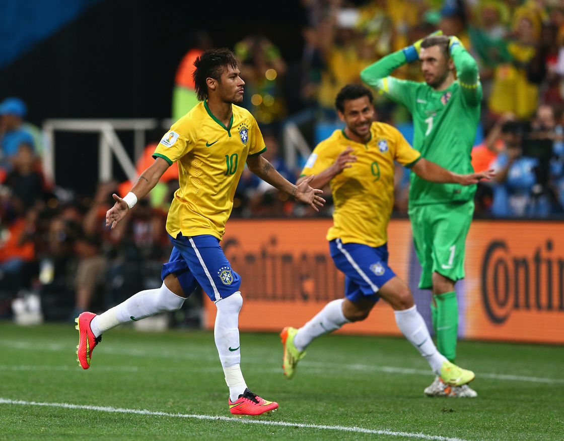Neymar of Brazil scores on a penalty kick to give the host nation a win to open the tournament.