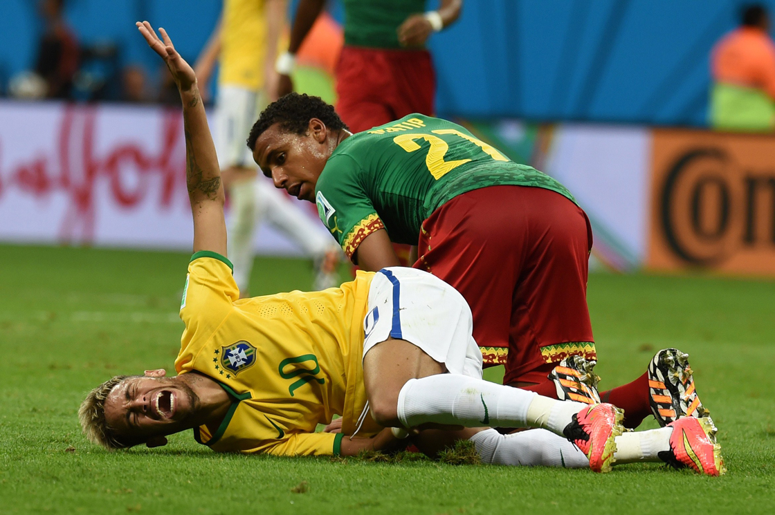 Brazil's Neymar writhes in agony after colliding with a Cameroon player. He was back on his feet in less than 15 seconds.