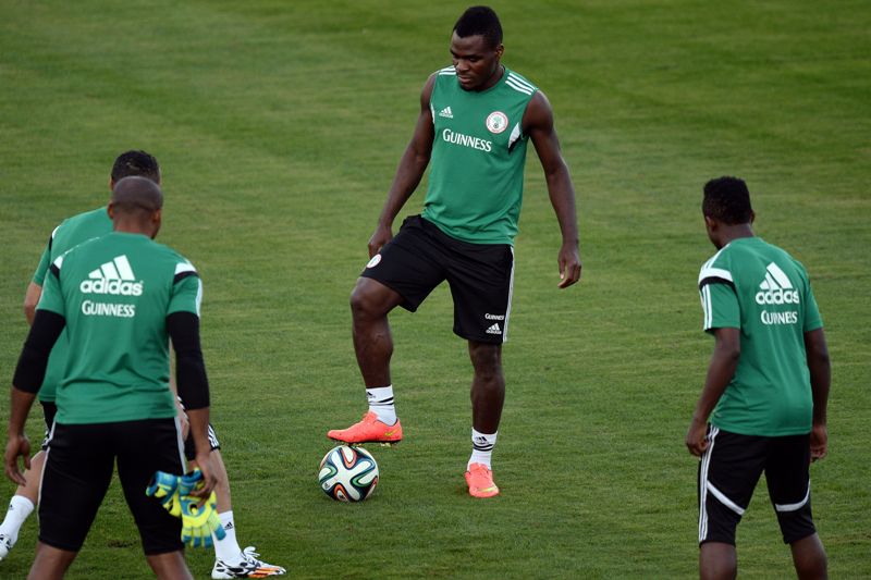 Nigeria's forward Emmanuel Emenike (C) warms up with teammates during a training session in Campinas on June 13, 2014 during the 2014 FIFA World Cup tournament in Brazil. AFP PHOTO/Jewel Samad        (Photo credit should rea.
