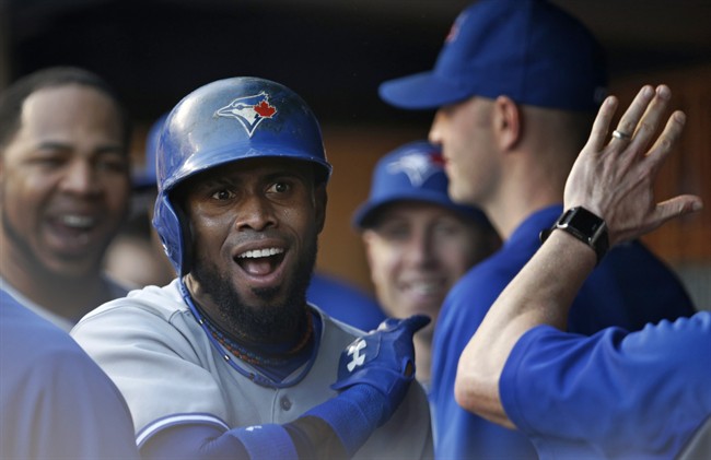 Toronto Blue Jays Jose Reyes reacts in the dugout as teammates greet him after he hit a first-inning lead-off solo home run off New York Yankees starting pitcher Masahiro Tanaka in a baseball game at Yankee Stadium in New York, Tuesday, June 17, 2014. 