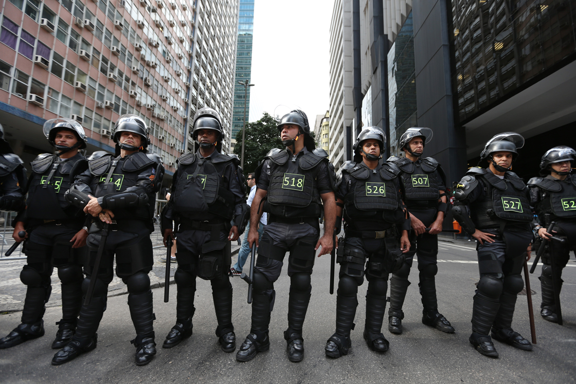 RIO DE JANEIRO, BRAZIL - JUNE 12: A line of police stand guard during an anti-World Cup demonstration on June 12, 2014 in Rio de Janeiro, Brazil. This is the first day of World Cup play. (Photo by Joe Raedle/Getty Images)