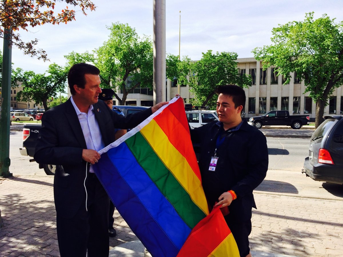 Michael Fougere is the first Regina mayor to raise the pride flag. He's accompanied by Dan Shier of Regina Pride.