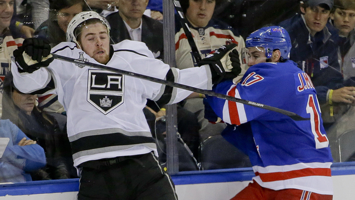 Los Angeles Kings left wing Tanner Pearson (70), left, crashes the boards with New York Rangers defenseman John Moore (17) in the third period during Game 4 of the NHL hockey Stanley Cup Final, Wednesday, June 11, 2014, in New York. 