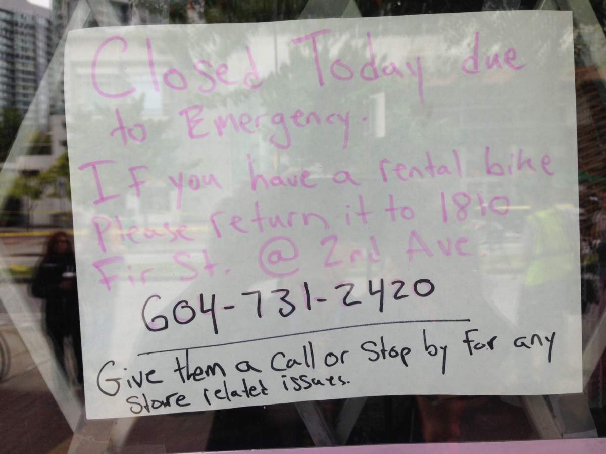 A sign on the window of Reckless Cycles on Davie Street where the first shooting occurred. Credit: John Daly, Global News