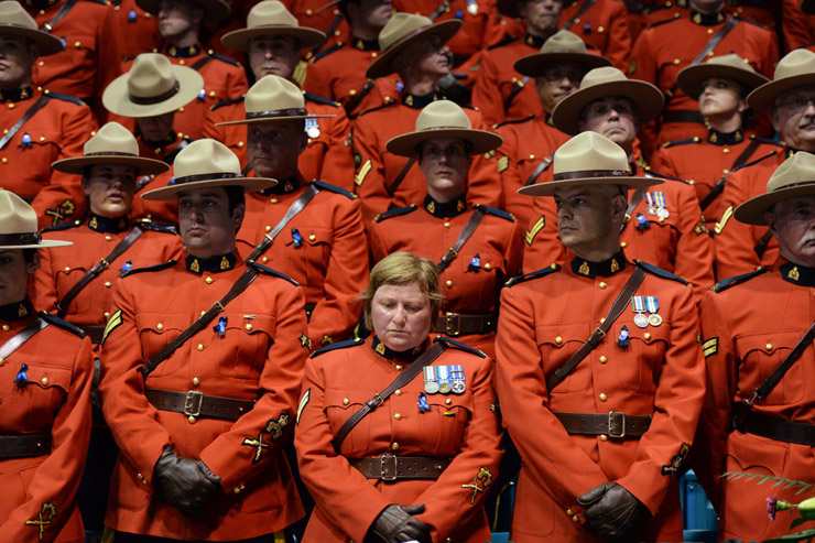 RCMP wait for the start of the regimental funeral for Const. Dave Joseph Ross, Douglas James Larche, and Fabrice Georges Gevaudan at the Moncton Coliseum
