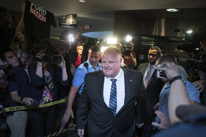 Toronto Mayor Rob Ford is greeted by a media throng as returns to his office at city hall in Toronto on Monday June 30, 2014