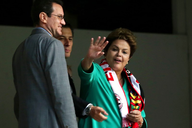 Brazilian President Dilma Rousseff waves as she visits Arena da Baixada stadium wich will host four matches of the upcoming FIFA World Cup Brazil 2014, in Curitiba, Brazil on May 9, 2014. AFP PHOTO /HEULER ANDREY        (Heuler Andrey/AFP/Getty Images).