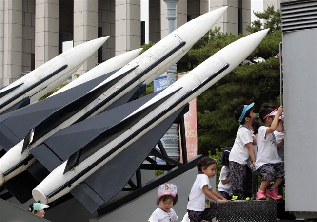 Kindergartners play beside South Korea's Hawk missiles on display at Korea War Memorial Museum in Seoul, South Korea, Friday, June 27, 2014. North Korea said Friday that leader Kim Jong Un has guided the test launches of its newly developed precision guided missiles, in a possible reference to three short-range projectiles South Korean officials say the North fired toward its waters a day earlier.(AP Photo/Ahn Young-joon).