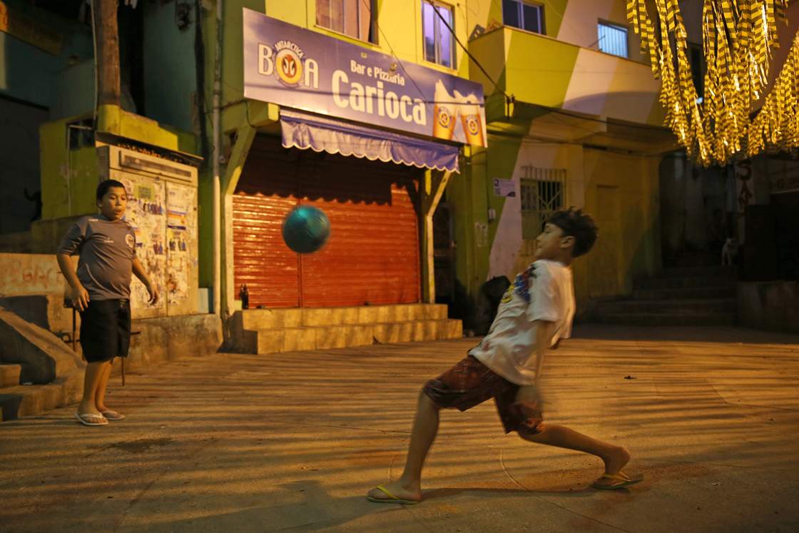 RIO DE JANEIRO, BRAZIL - JUNE 08: Children play a game of soccer in the streets of a 'favela' called Santa Marta on June 8, 2014 in Rio de Janeiro, Brazil. Brazil continues to prepare to host the World Cup which starts on June 12th and runs through July 13th. (Photo by Joe Raedle/Getty Images)