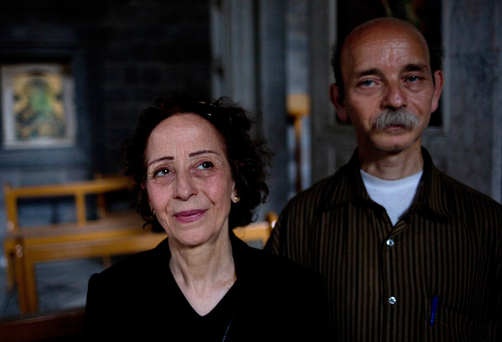 In this Thursday, June 5, 2014 photo, Zeinat Akhras and her brother Ayman pose inside a Greek Orthodox church in Homs, Syria. 