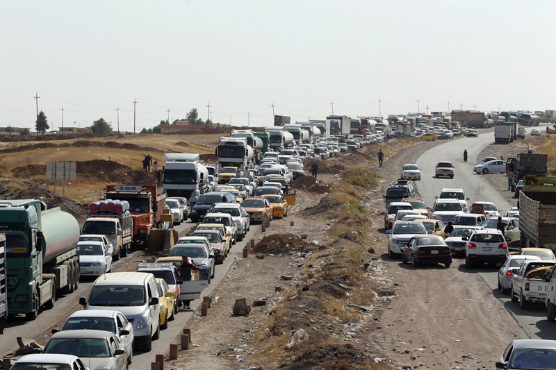Traffic from Mosul queues at a Kurdish Check point on June 14, 2014 in Kalak, Iraq.  (Photo by Dan Kitwood/Getty Images).