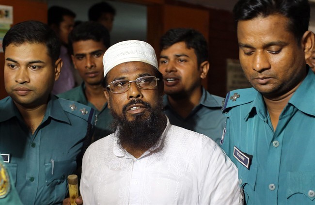 Mufti Abdul Hannan, leader of banned radical group Harkatul Jihad al Islami, stands at a court in Dhaka, Bangladesh, June 16, 2014.