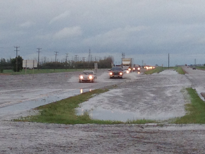 Water washes over the Trans-Canada Highway on Sunday evening.