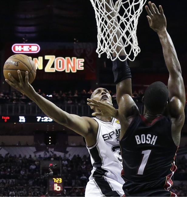 San Antonio Spurs forward Boris Diaw shoots as Miami Heat center Chris Bosh (1) defends during the first half in Game 2 of the NBA basketball finals on Sunday, June 8, 2014, in San Antonio. (AP Photo/Eric Gay).