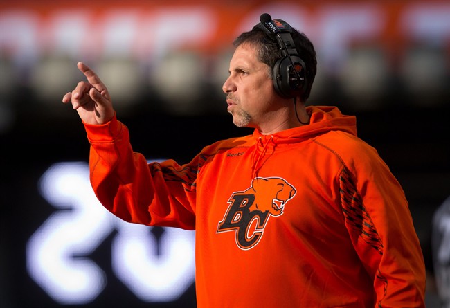 Former B.C. Lions' head coach Mike Benevides stands on the sideline during the first half of a pre-season CFL football game against the Calgary Stampeders in Vancouver, B.C., on Friday June 20, 2014. 