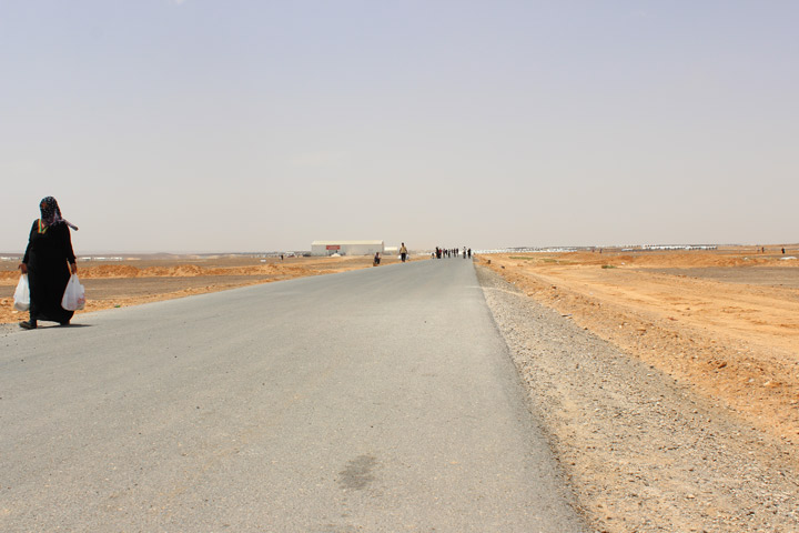 A woman walks home from the supermarket in Azraq
