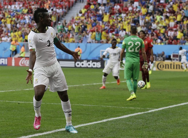 Ghana's Asamoah Gyan celebrates after scoring his side's first goal during the group G World Cup soccer match between Portugal and Ghana at the Estadio Nacional in Brasilia, Brazil, Thursday, June 26, 2014.