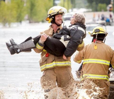 Firefighter Shawn Wiebe still smiling, one year after iconic flood photo - image