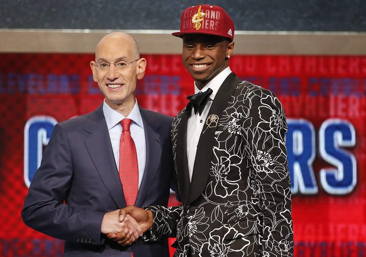 NBA Commissioner Adam Silver, left, congratulates Andrew Wiggins, who was selected by the Cleveland Cavaliers as the number one pick in the 2014 NBA draft, Thursday, June 26, 2014, in New York.