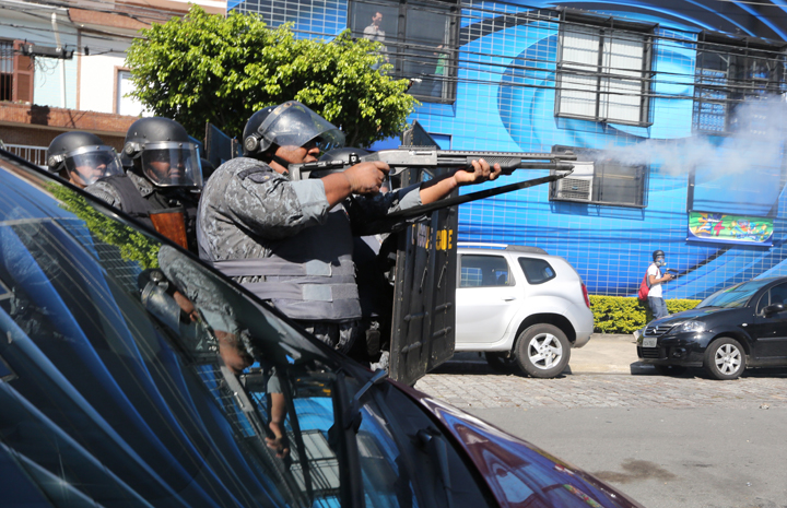 Police fire non-lethal rounds at protestors during a World Cup protest outside Carrao Metro Station on June 12, 2014 in Sao Paulo, Brazil.